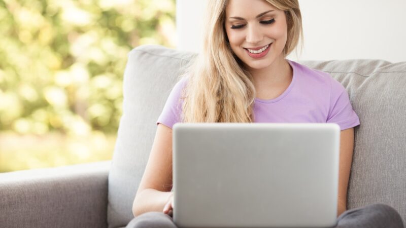young beautiful woman using a laptop to create a Christian website