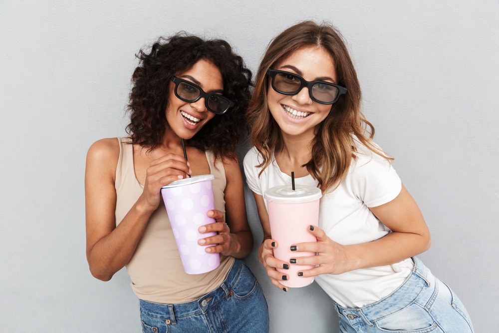 Two young happy women with cups